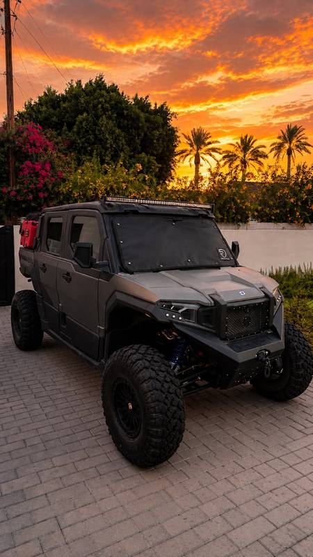 Custom side-by-side with a FIT windshield cover at sunset